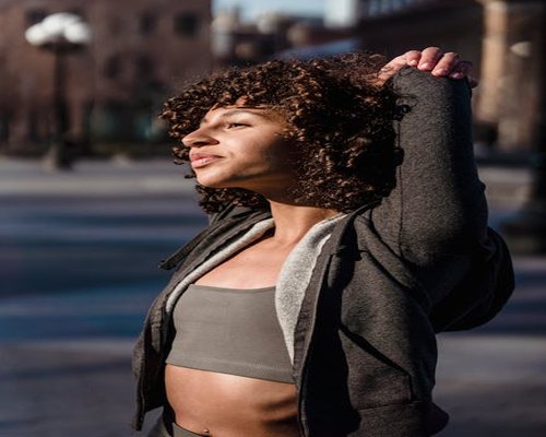 Woman enjoying morning breeze and light stretching outdoors